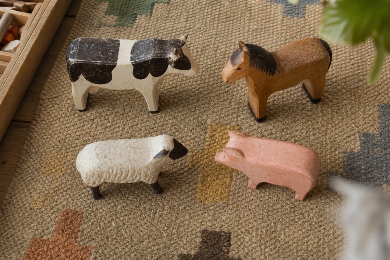 Painted farm animals seen from above on the rug