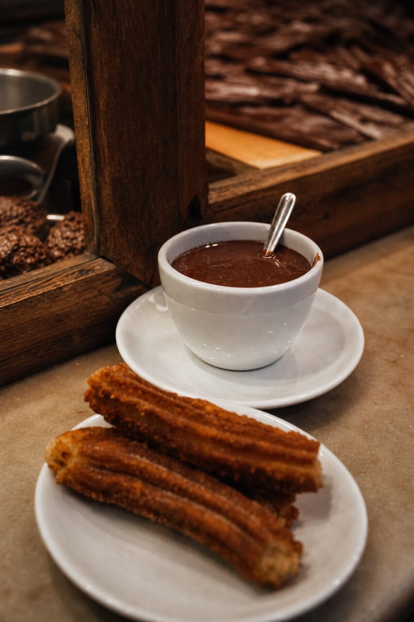 Close-up of a hot chocolate cup and churros
