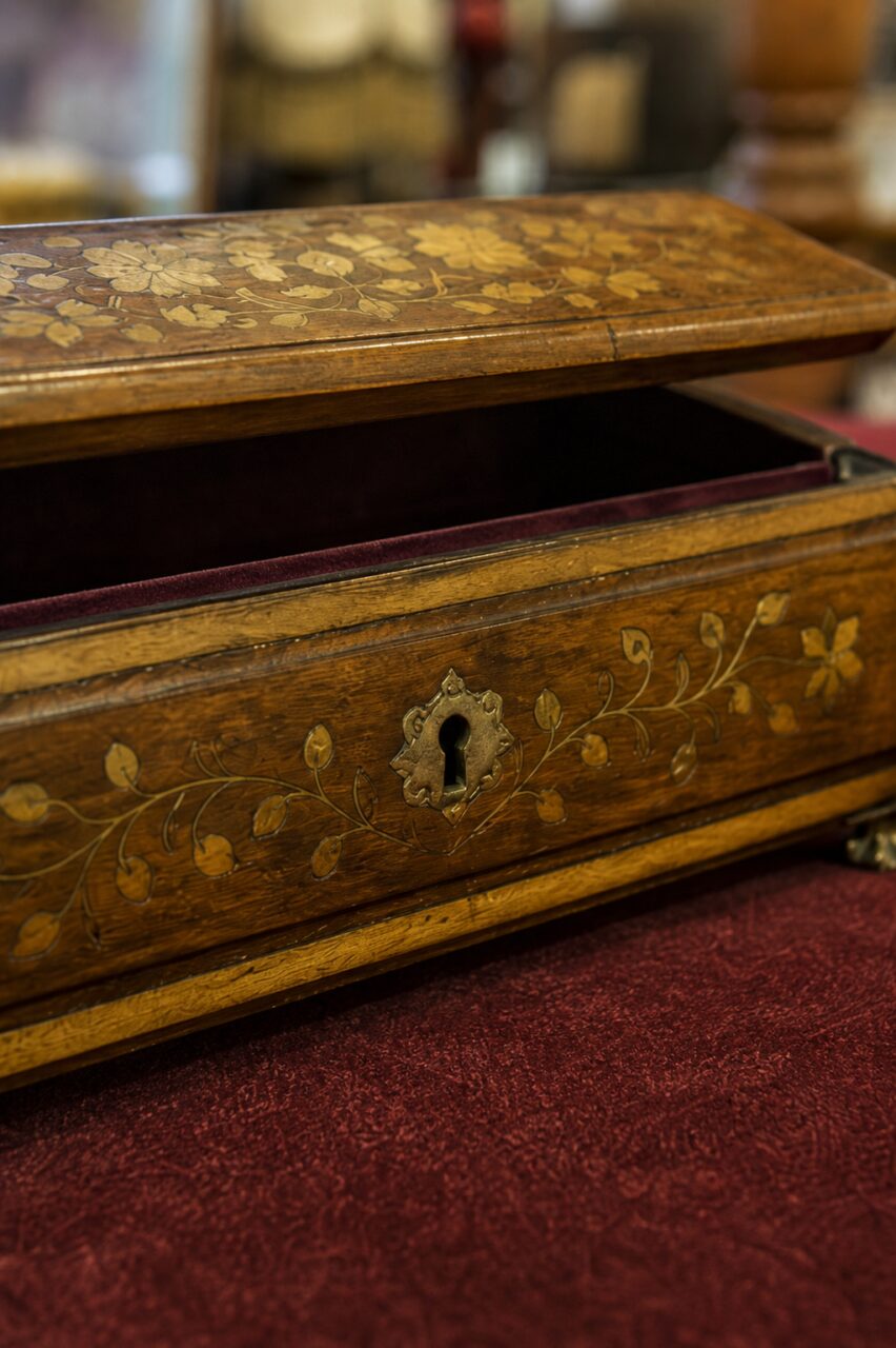 Close-up of the floral inlay and keyhole on an antique jewellery box