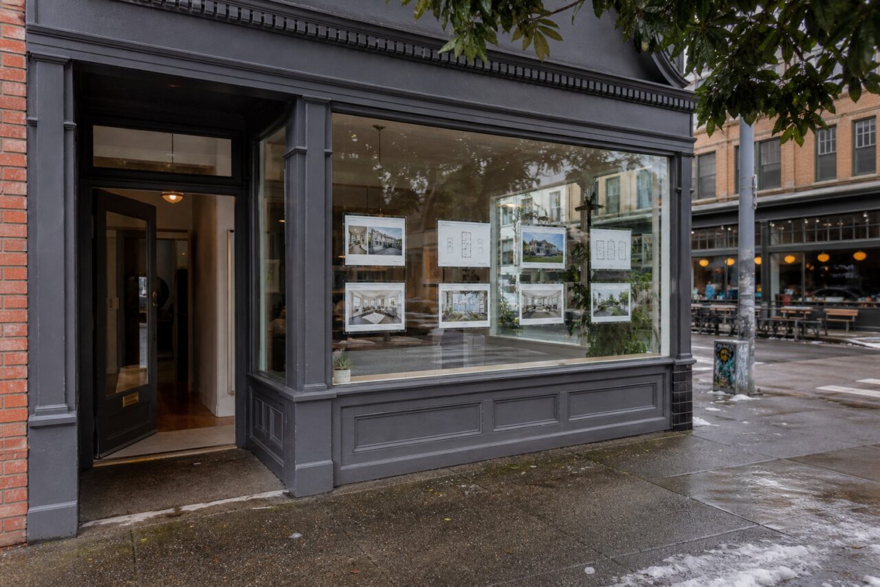 Real estate agency storefront with property listings