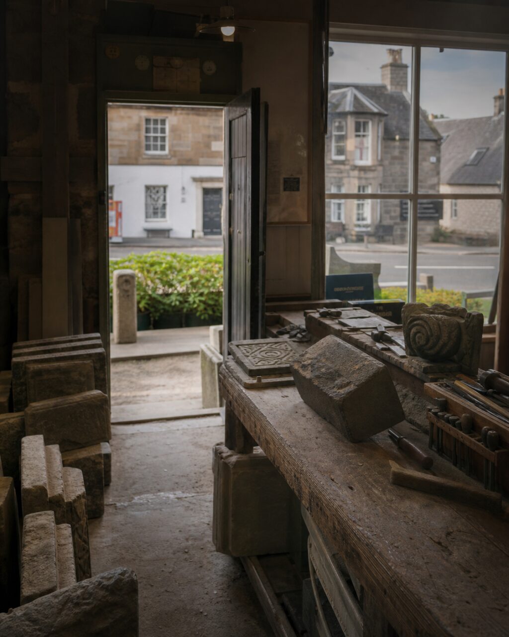Stone workshop interior looking toward the street and bench