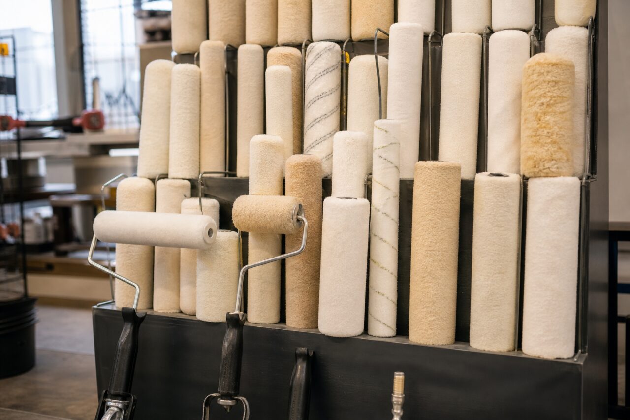 Display of white and beige paint rollers and sleeves
