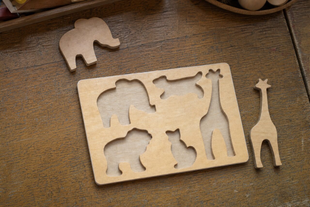 Houten puzzel van boven met olifant en giraffe eruit