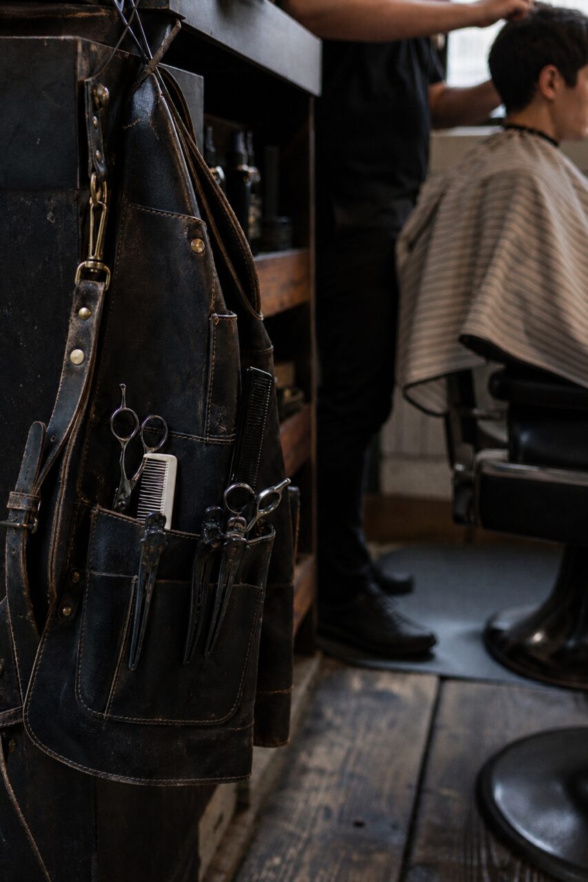 Tool apron in the foreground beside a seated person
