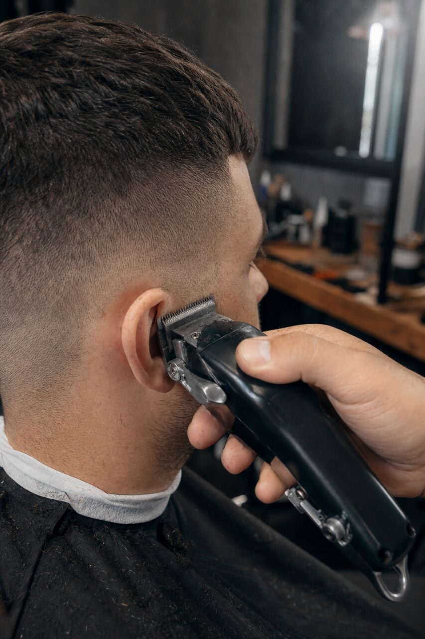 Clippers working around the ear for a short clean fade