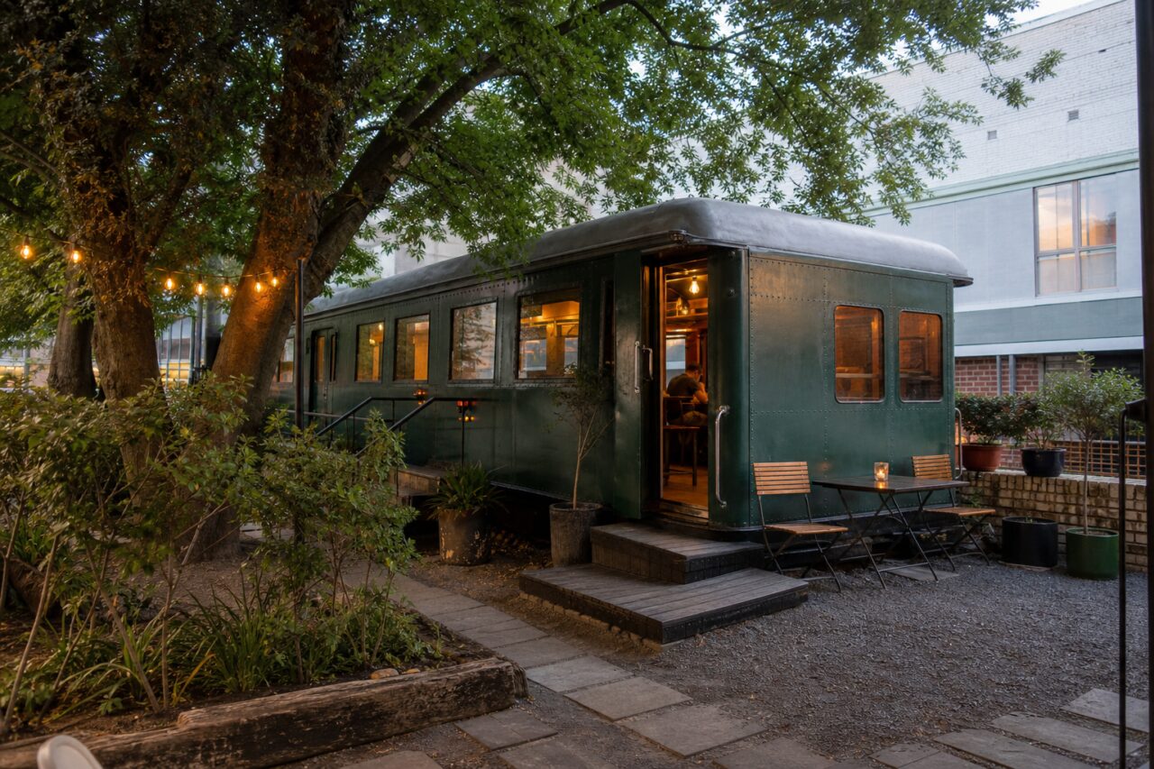 Wide view of the green café in a tree-filled courtyard